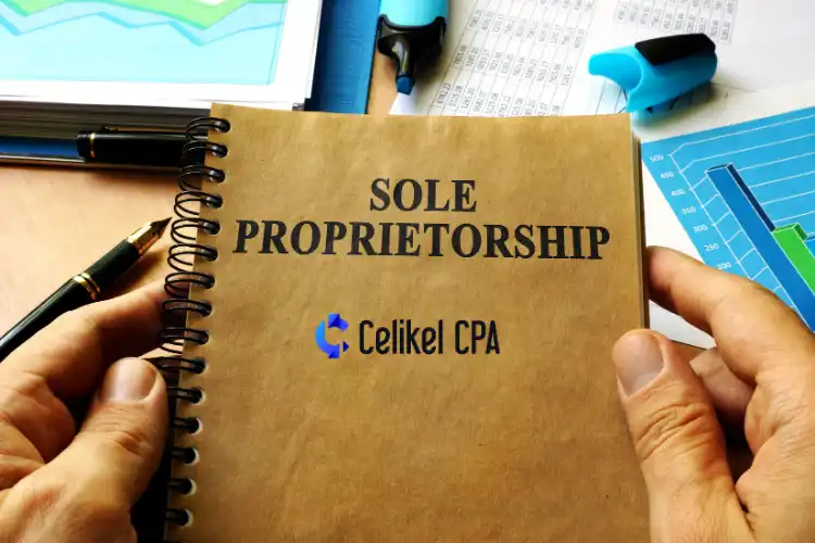 A person holding a brown spiral notebook with the title "Sole Proprietorship" and the Celikel CPA logo on the cover. Business documents and financial charts are visible in the background.